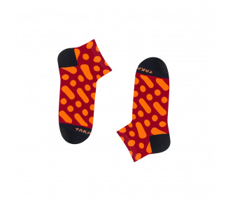 Colorful sneaker socks Wilcza 13m4 with orange dots and stripes on a red background. Takapara