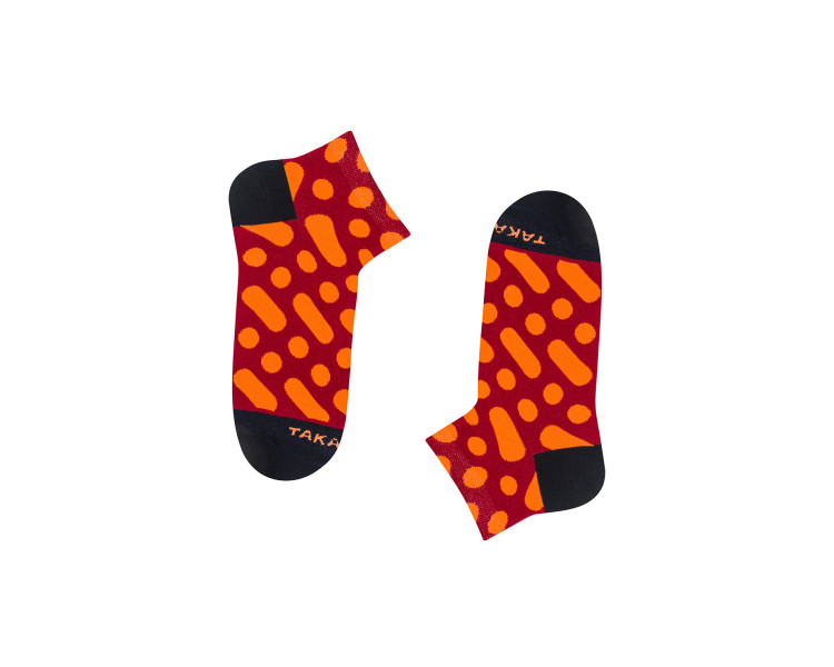 Colorful sneaker socks Wilcza 13m4 with orange dots and stripes on a red background. Takapara
